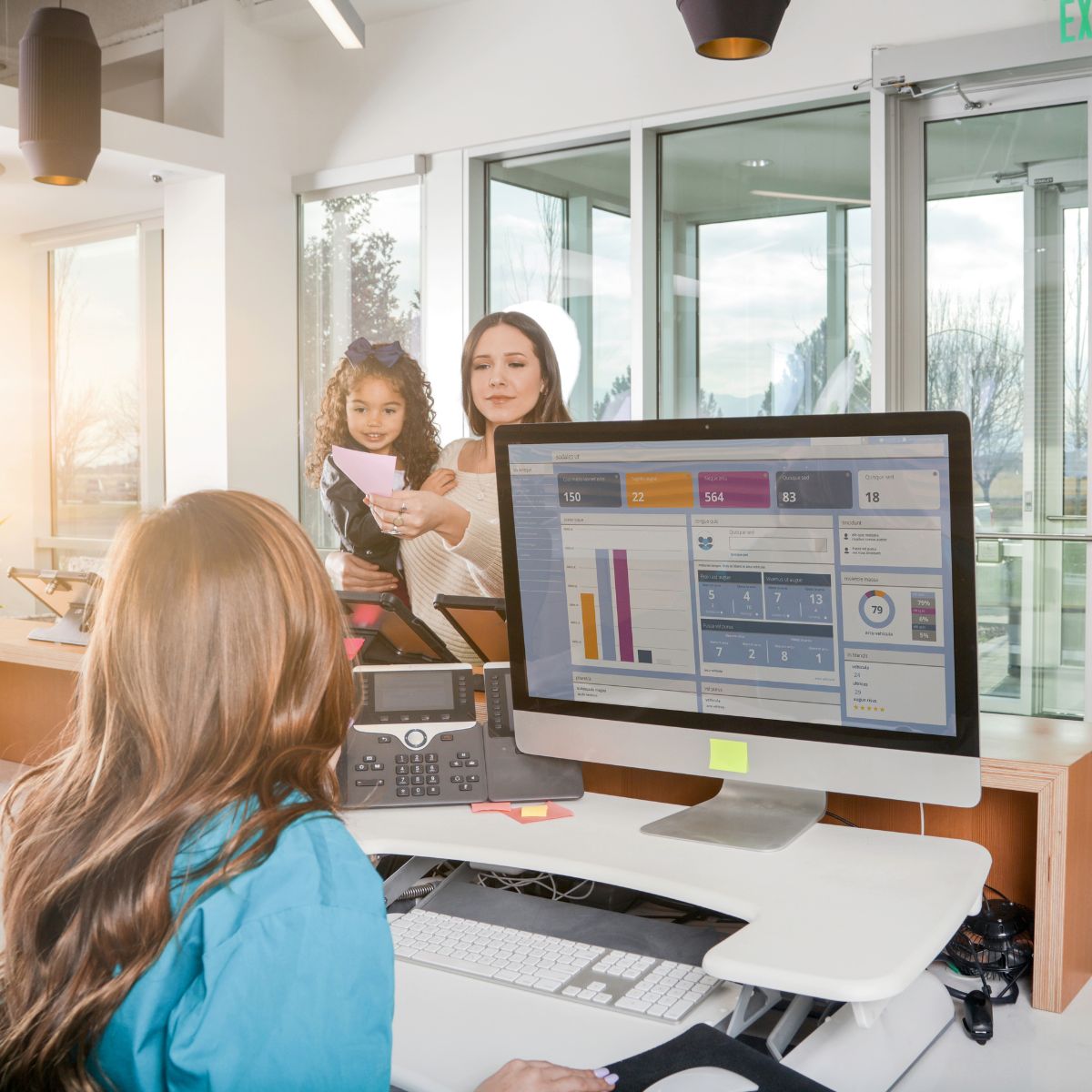 property manager speaking to a guest in reception used on a blog about the functions of a property management system