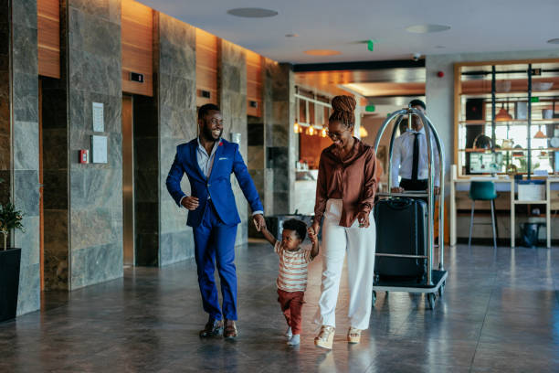 mum, dad and small child in the lobby of a hotel used in a blog about online hotel booking software